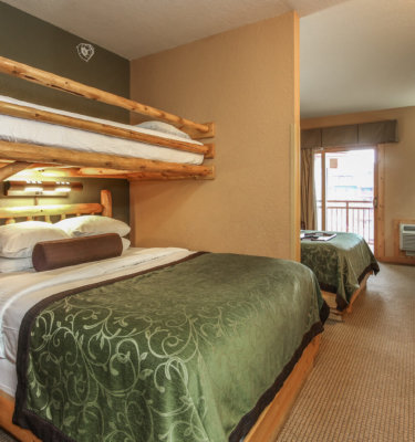 A hotel room with bunk beds and a balcony