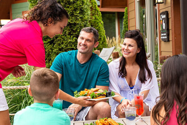 Cabana Forest family being served food by a waitress