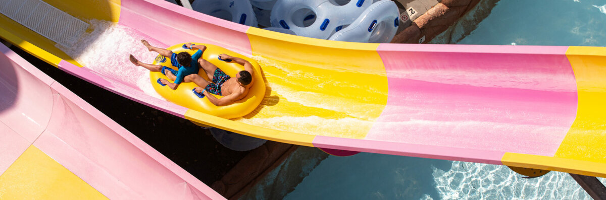 the wall two people sliding in a tube