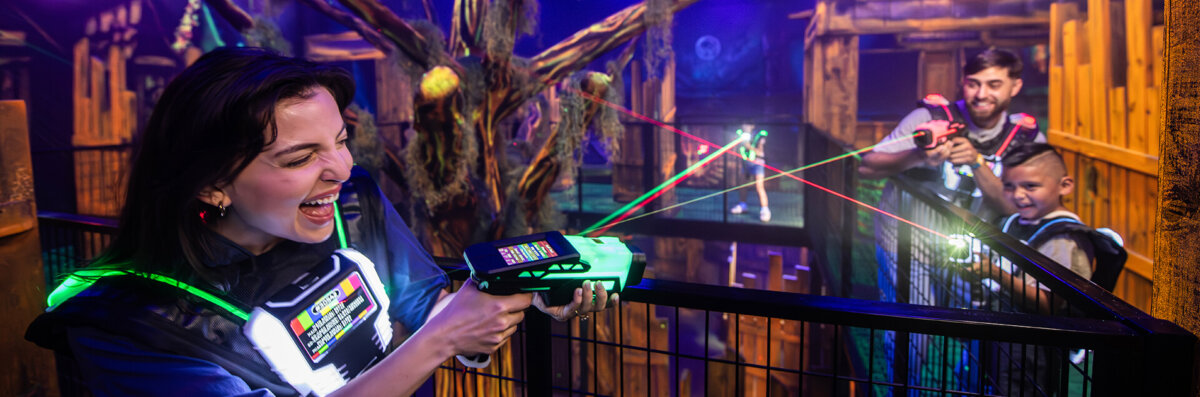 Fury In The Forest website banner image shows family playing laser tag at Wilderness at the Smokies