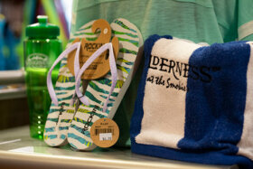 retail store photo of water bottle sandals and a towel