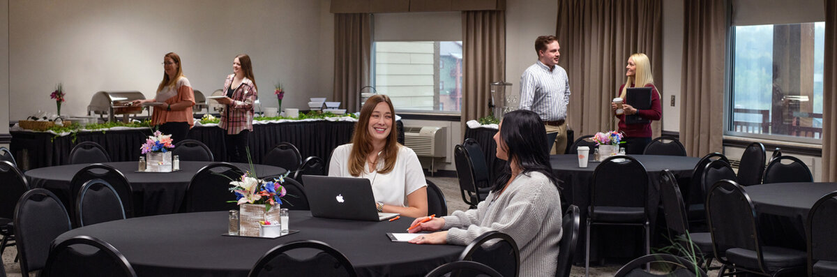 Banner image of a large group of professionals attending a conference in a spacious meeting hall at Wilderness at the Smokies, showing the venue's capacity for corporate events.