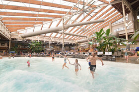 family running into the wave pool at the wild waterdome indoor park
