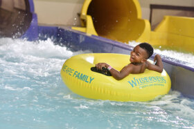 small child floating in a tube