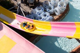 couple sliding on the wall outdoor waterslide