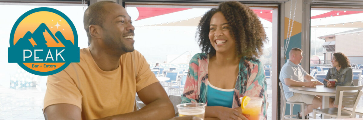 couple having a drink at peak bar and eatery