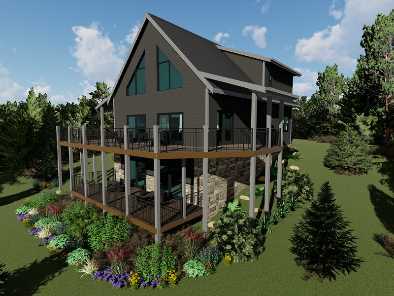 A large house with a wraparound porch and balcony surrounded by trees and a garden.