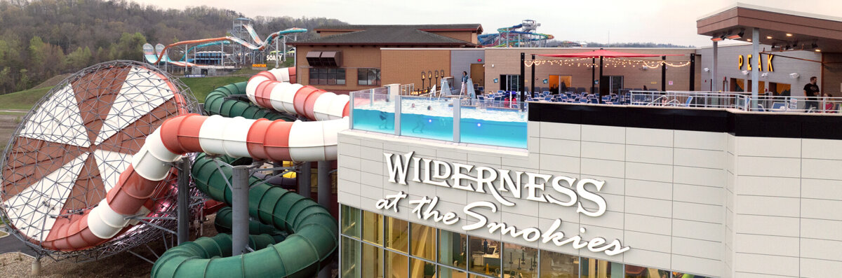 Lookout Lagoon roof top pool Wilderness at the Smokies. Image shows rooftop pool with swimmers enjoying the outdoor weather. Used as a banner to show view and location on pool website page.