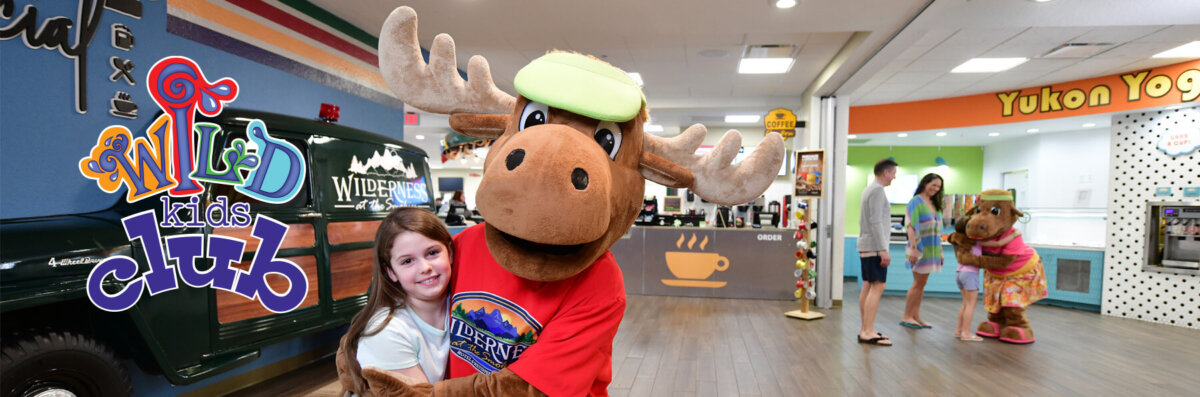 Wild Kids Club logo next to mascots Monty and Molly the Moose hanging out at the Camp Social food hall in Wilderness at the Smokies.